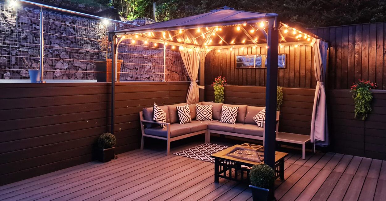 String lights installed around a decking seating area