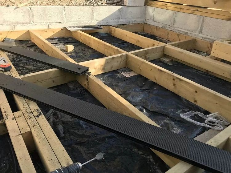 Timber frame foundation prepared for charcoal composite decking installation with integrated lighting system